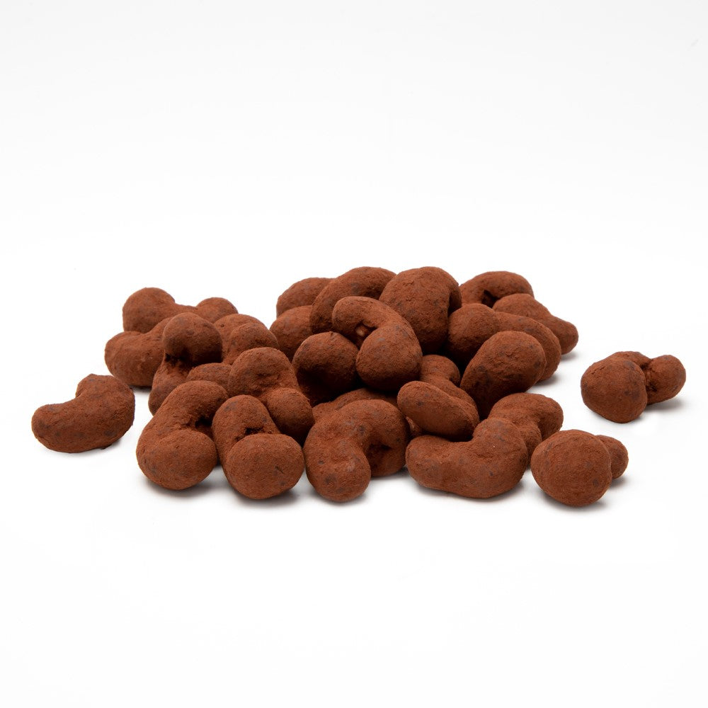 Premium roasted cashews coated in Belgian chocolate and dusted with rich cocoa powder on a white background.