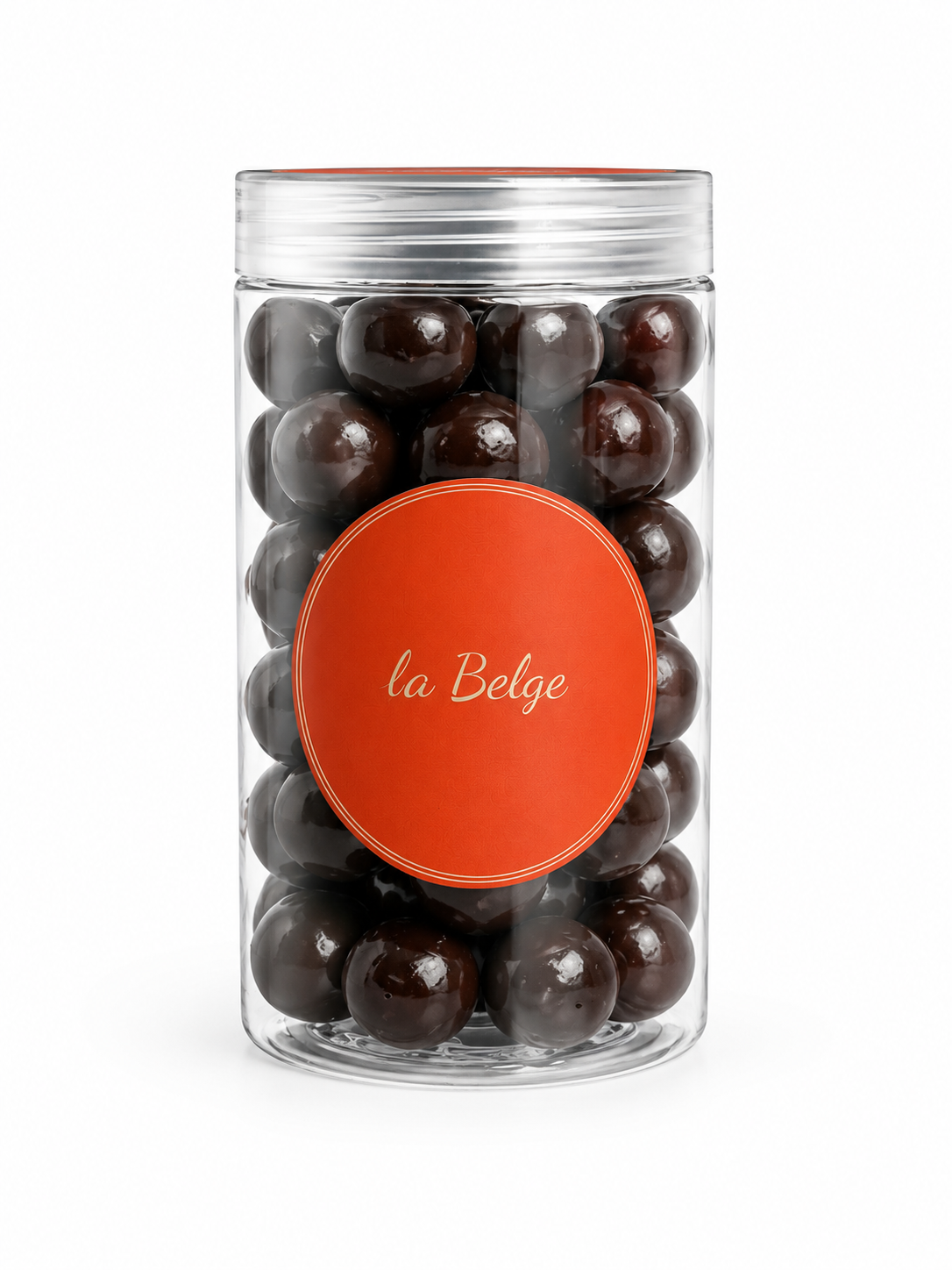 Premium Belgian dark chocolate coated hazelnuts in a clear La Belge cylinder.