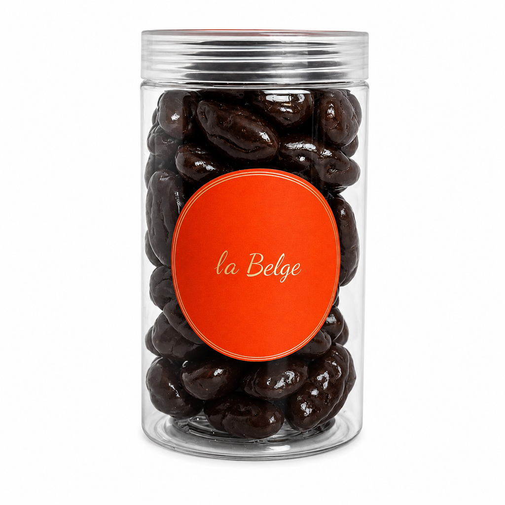 Premium Belgian dark chocolate coated pecans in a clear La Belge cylinder.