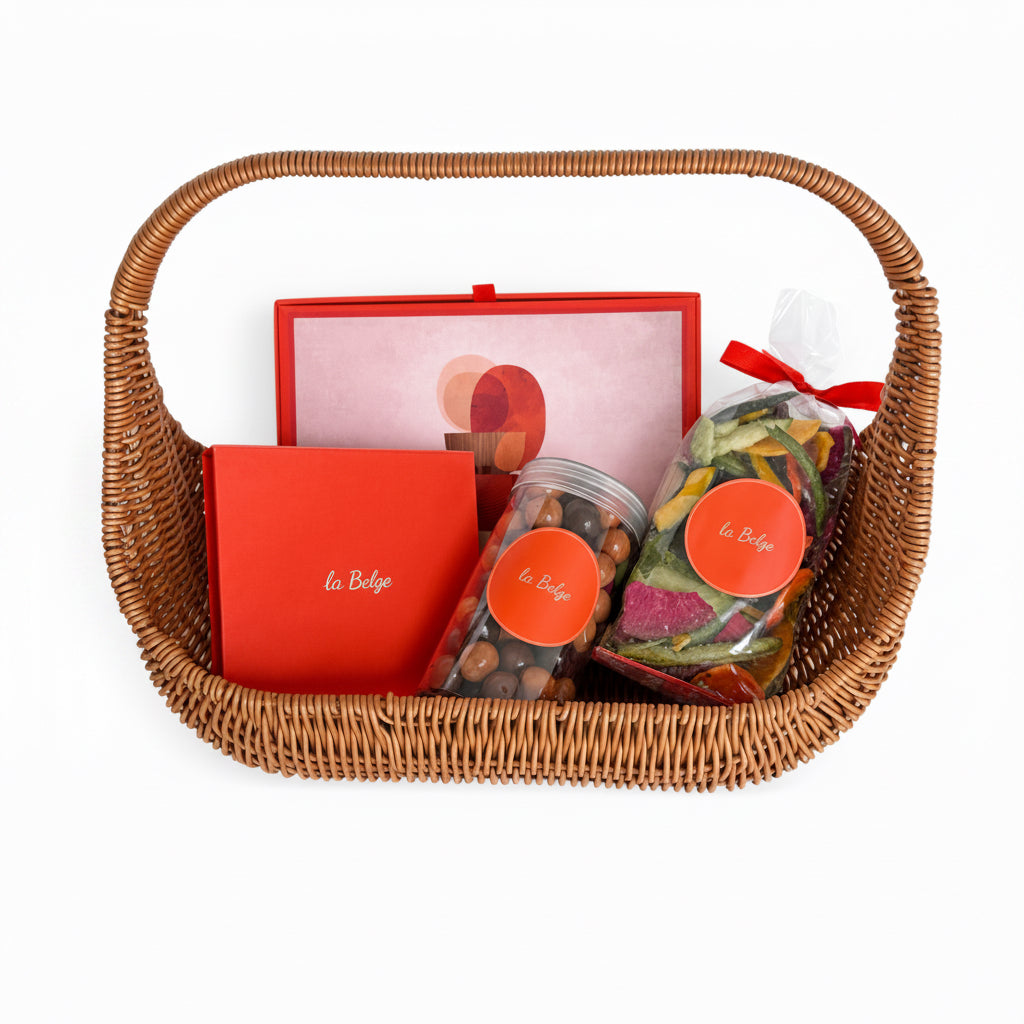 La Belge woven basket gift set with chocolate domes, stuffed dates, hazelnuts, and dried vegetables
