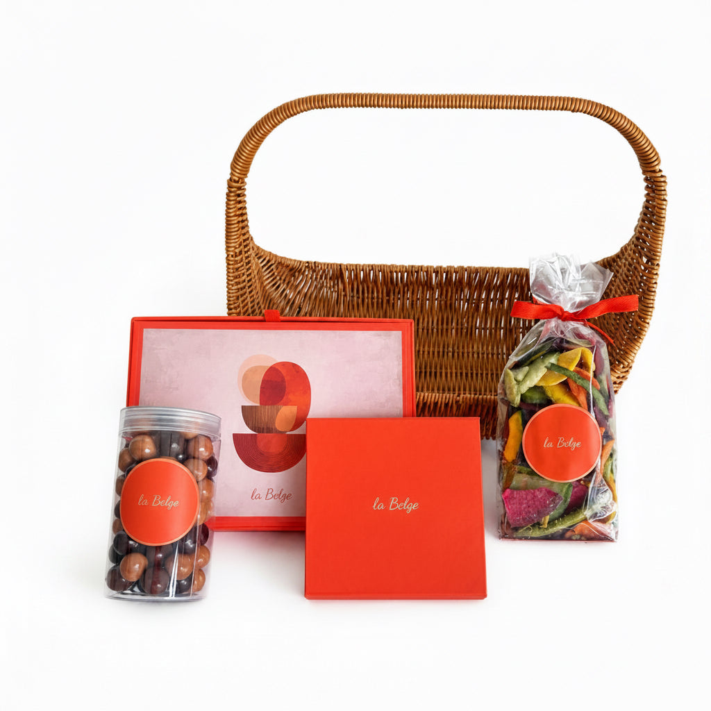 La Belge woven basket gift set with chocolate domes, stuffed dates, hazelnuts, and dried vegetables